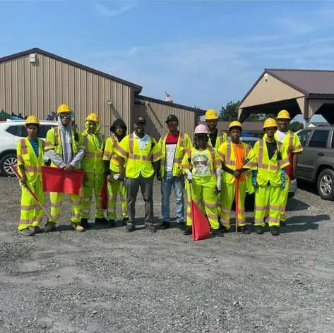 One Flagger Inc crew lined up in safety gear with flags