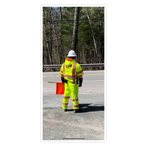 One Flagger Inc crew member in full gear on the road with flag
