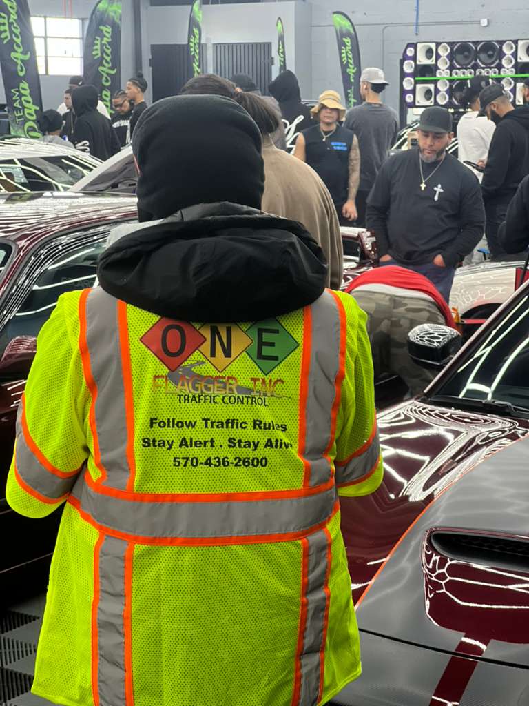 One Flagger Inc safety vest with company slogan